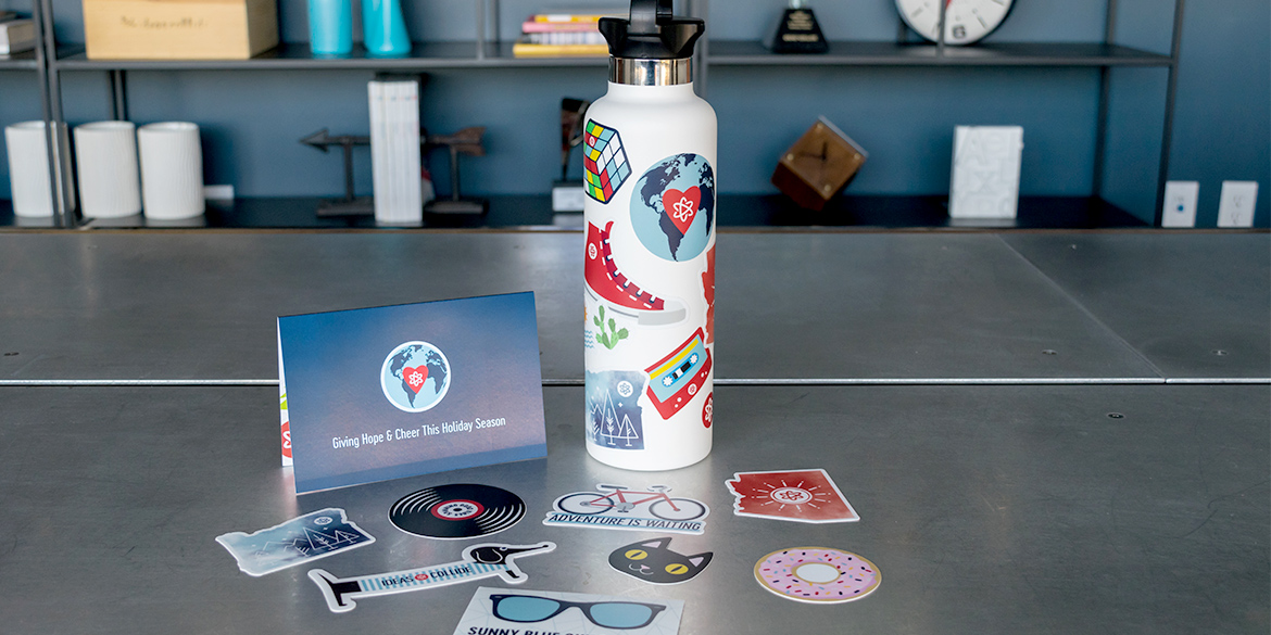 New Ideas Collide branding on water bottle and stickers